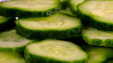 close-up view of rotating sliced green cucumbers.