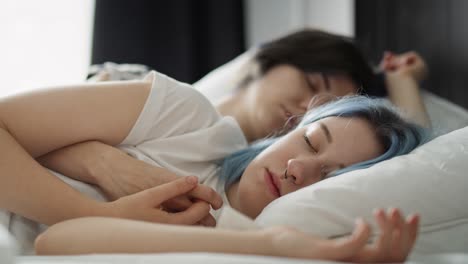 handheld video of lesbian couple sleeping together in bed