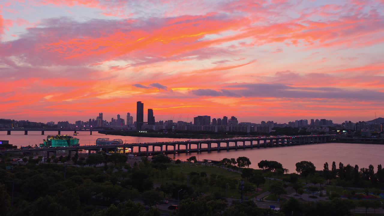 Aerial cityscape of Seoul at sunset with Banpo Bridge over Han river and dramatic purple orange clouds in the sky