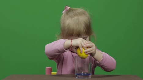 Beautiful-young-girl-squeezes-lemon-juice-with-a-grimace-on-her-face