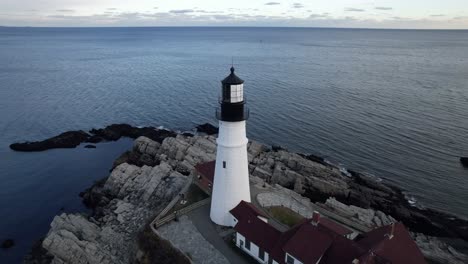 aerial parallax of portland head lighthouse, winter time in maine on cape elizabeth coast