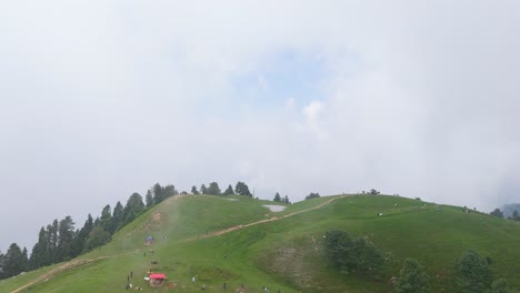 drone flyover of mushkpuri top | aerial view of green meadows and clouds