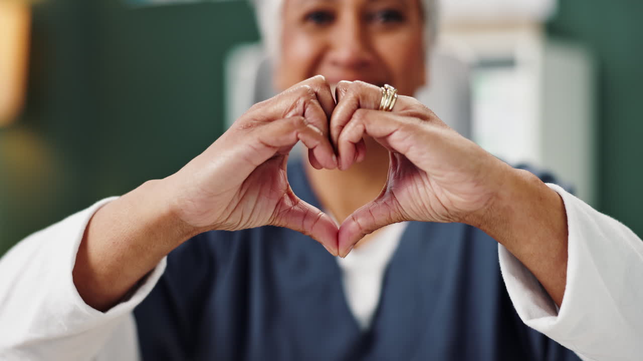 Senior woman making heart shape with hands