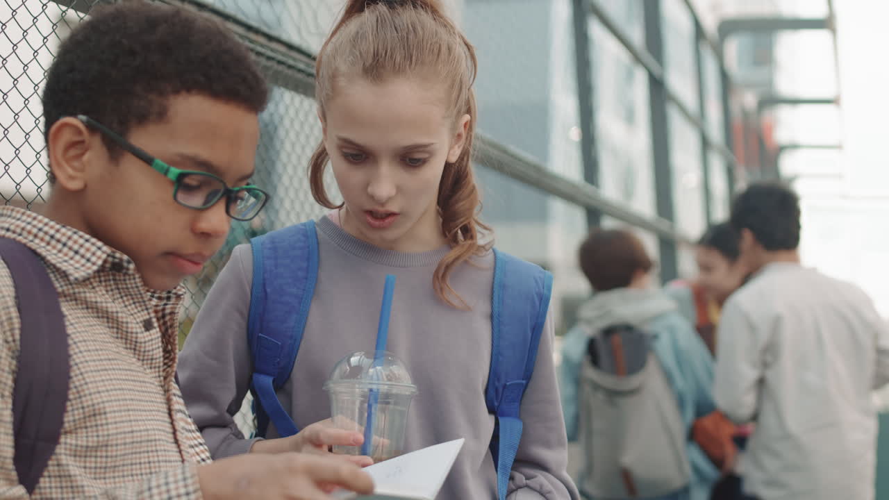 School Children Talking about Homework Outdoors