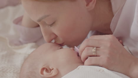 mother kissing baby