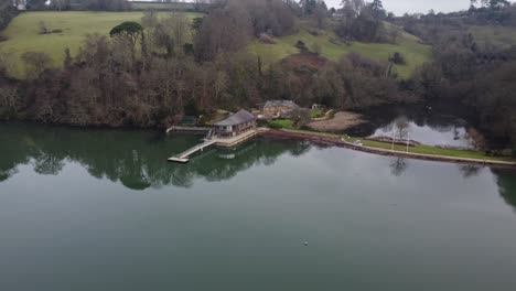 aerial footage of a stunning waterfront house with a large lake behind