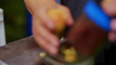 Close-up-shot-of-male-hands-taking-apples-from-the-basket-and-putting-them-in-the-apple-juice-machine