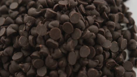 Video-of-close-up-of-multiple-chocolate-chip-over-white-background