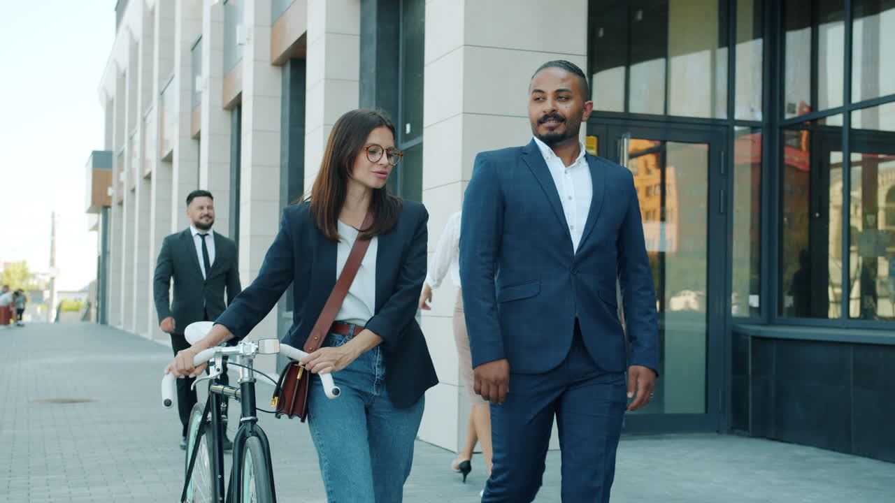 Business Colleagues Walking and Talking Outside Office Building