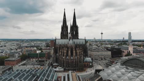 aerial drone footage circling the cologne cathedral along the shore of the rhine river in germany