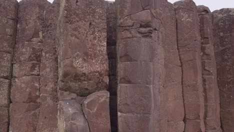 Scablands-tilt-up-cracked-basalt-rock-columns-to-blank-white-sky-above