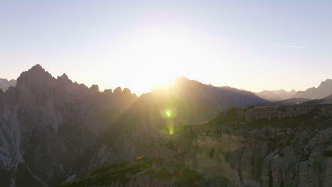 tre cime sunrise mountain peaks aerial view flying across extreme rocky south tyrol valley terrain