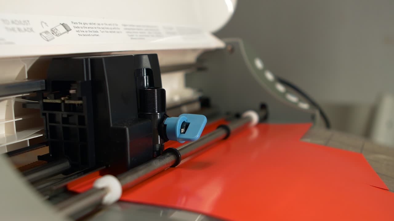 A desktop cutter is cutting foil