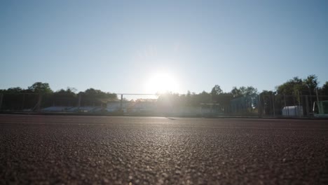 female athlete running on outdoor track in sportswear