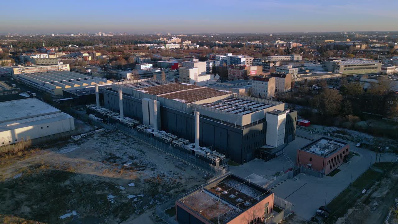 Large modern data center building providing essential services for artificial intelligence and cloud computing. Unique aerial view static tripod hovering panorama overview drone