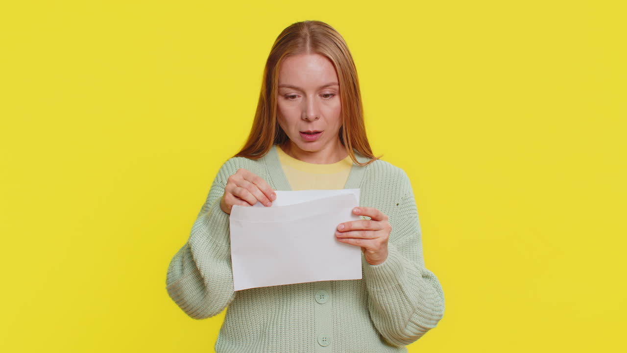 Happy young woman open envelope take out letter reads bank loan approve great news award win