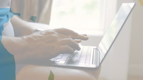 animation of shapes over senior biracial man using laptop