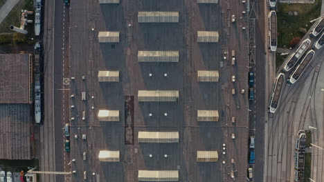 aerial view of an industrial complex with trains and parking