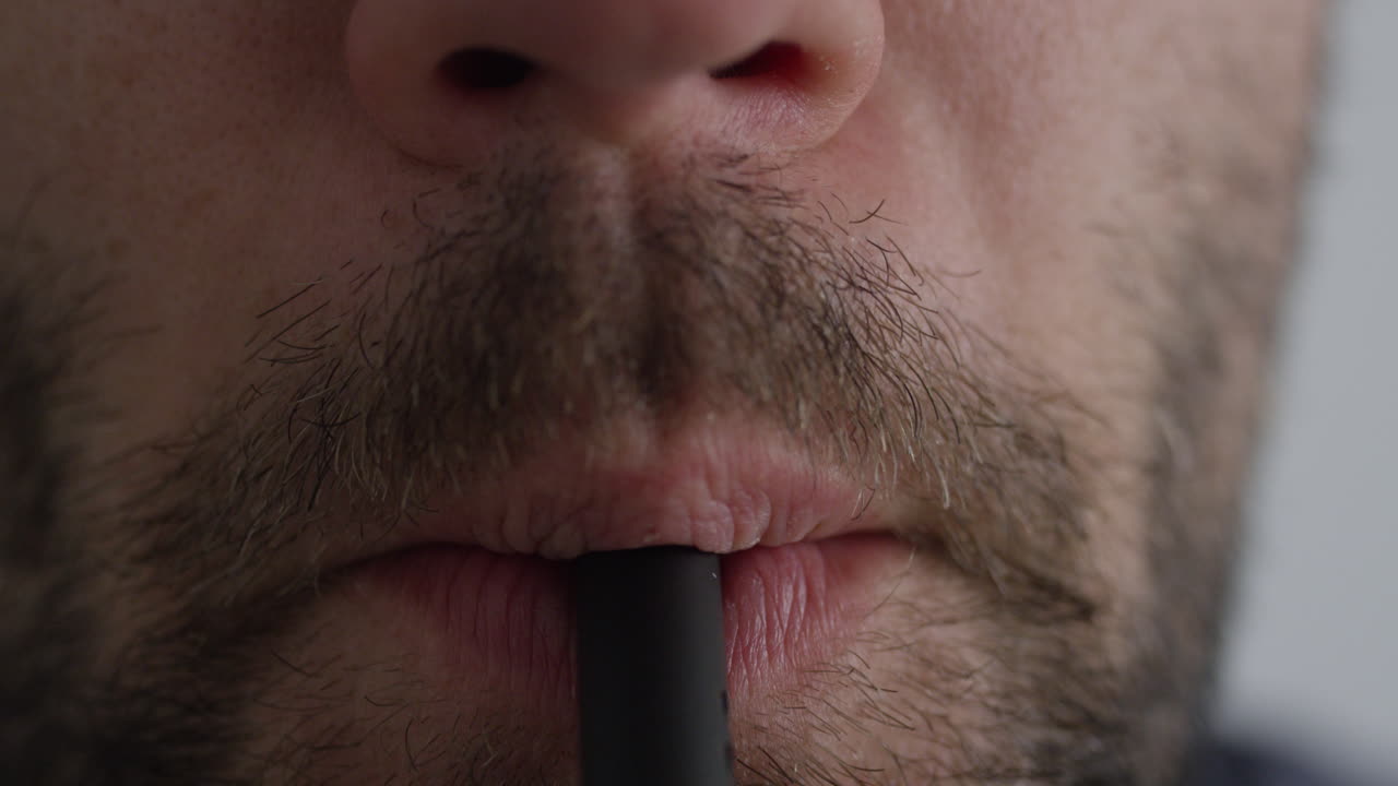 macho adulto fumando un bolígrafo vape