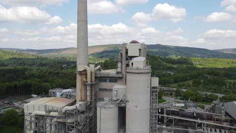 Aerial-drone-flight-around-the-main-building-of-Breedon-Hope-Cement-Works-with-a-panoramic-view-of-the-surrounding-Peak-District