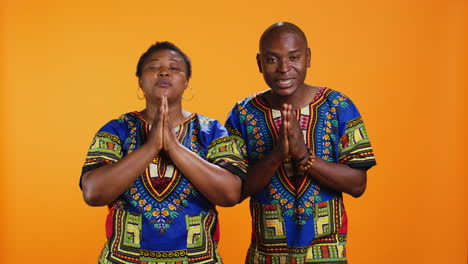 spiritual ethnic people posing with folded hands sign