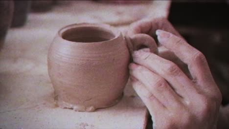 young woman makes a jug of clay. female hands mold pottery. vintage effect.