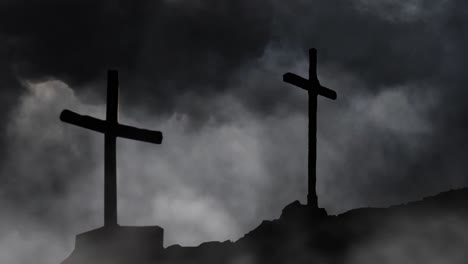 stone hill with two crosses silhouette dark clouds background