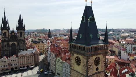 drone medieval prague square with famous clock tower and twin-spired church
