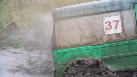 green suv in a mud pit