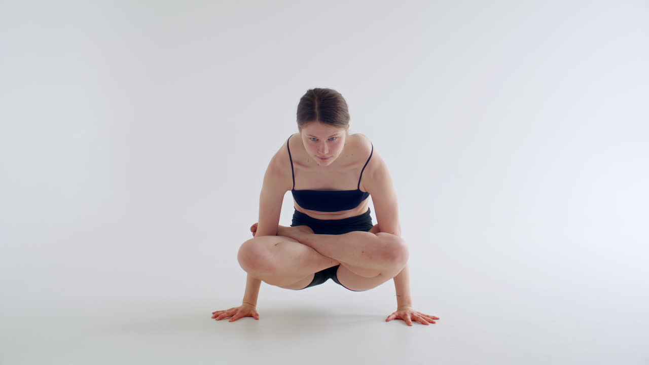 Young Strong Woman Holding Scale Pose during Hatha Yoga Practice