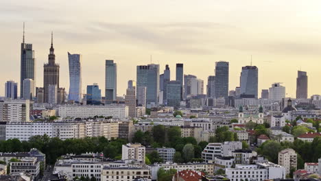 warsaw skyline with varso place and palace of culture and science building at sunset in poland. - aerial shot