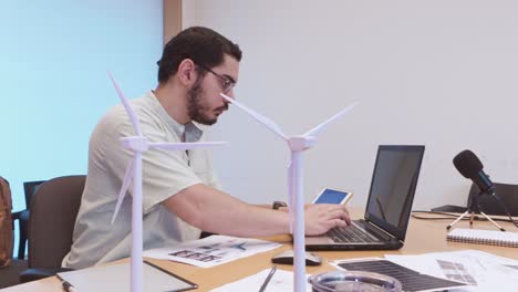 content creator discussing green energy with microphone and models