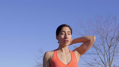 young fit woman fixing hair before outdoor run