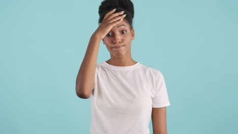 Woman with afro hair doing facepalm