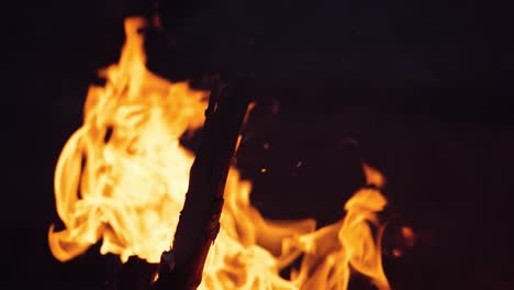 A closeup of a campfire. Beautiful fire burns brightly. Embers of the fire climb up. Slow motion