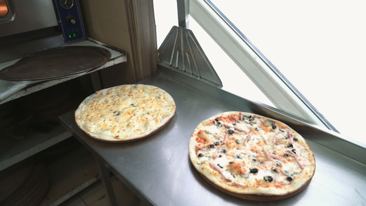 Professional chef puts just now cooked pizza. Italian Pizza putting out from oven. Ready for delivery