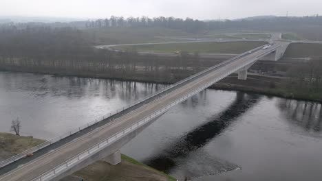 aerial footage showing a dump truck crossing the new destiny bridge on river tay before the official opening.