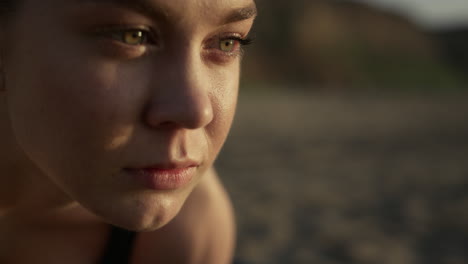 closeup of attractive woman face with confident gaze into distance outdoors.