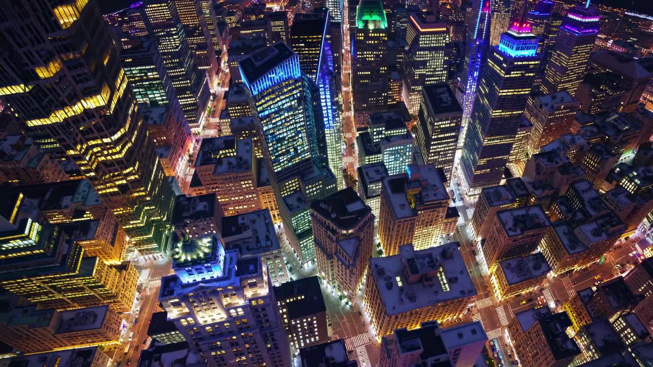 Illuminated Manhattan skyscrapers creating a mesmerizing urban landscape at night, showcasing a vibrant cityscape filled with glowing lights and modern architecture