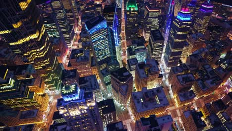 illuminated manhattan skyscrapers creating a mesmerizing urban landscape at night, showcasing a vibrant cityscape filled with glowing lights and modern architecture