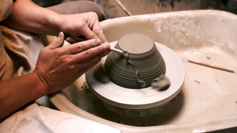 Mid-section-of-potter-making-pot