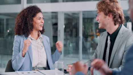 business colleagues high-fiving in office celebrating success