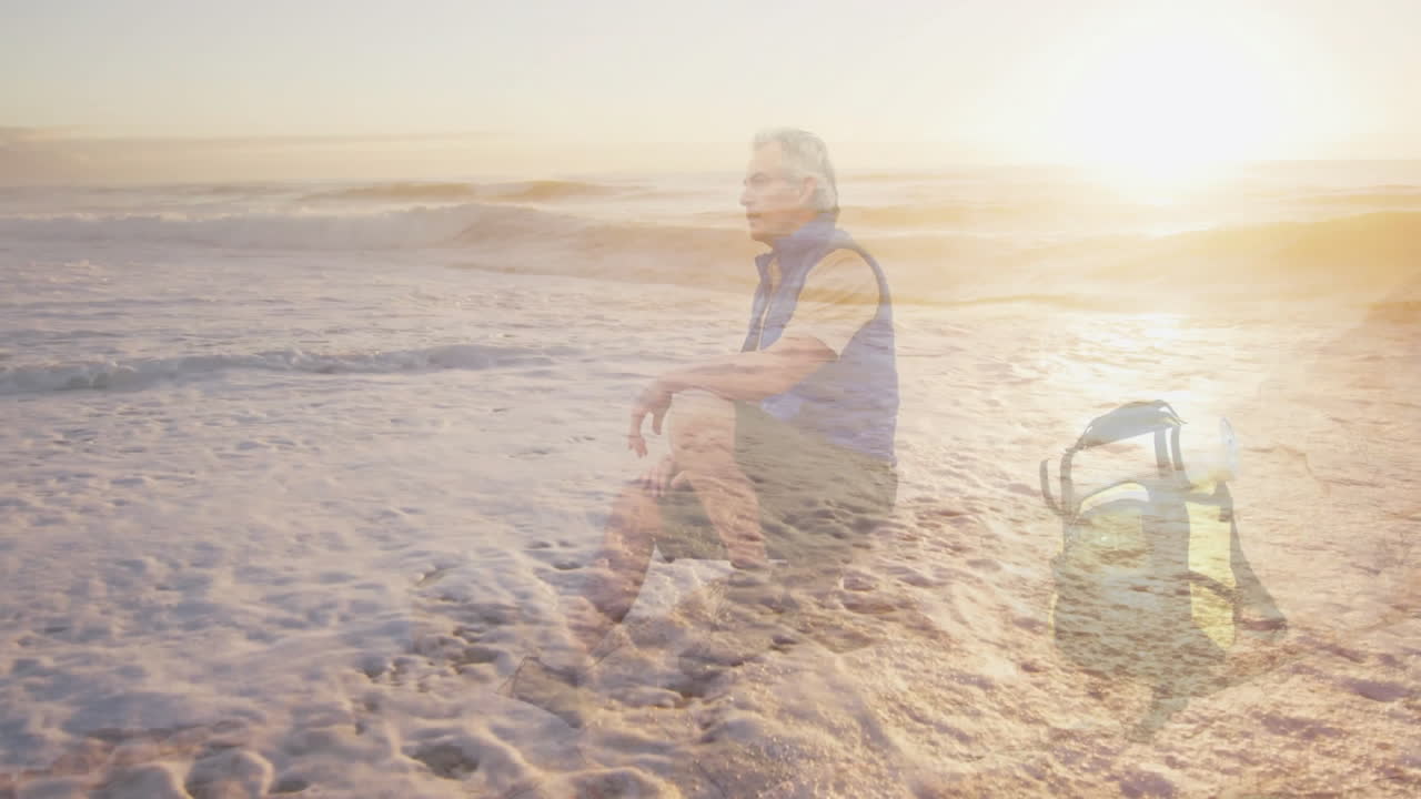 Mature man sitting wet sand shoreline, displaying health data graphs over sunrise waves