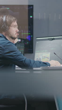 african american stock trader communicates with investment adviser about real-time stocks and exchange market charts on computer. businesspeople work in broker agency office. vertical shot