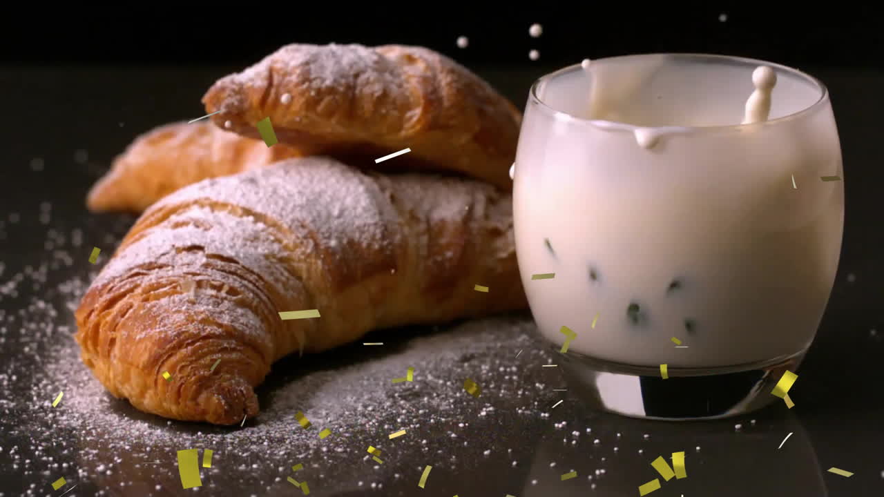 croissants con azúcar en polvo y un vaso de leche con animación de confeti