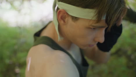 hair view adventurer wearing headband and tank top moving dynamically during combat training in forest environment hair swinging with body motion conveying intense action and adventurous spirit