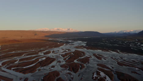 Rising-pan-down-aerial-shot-over-Iceland-braided-rivers