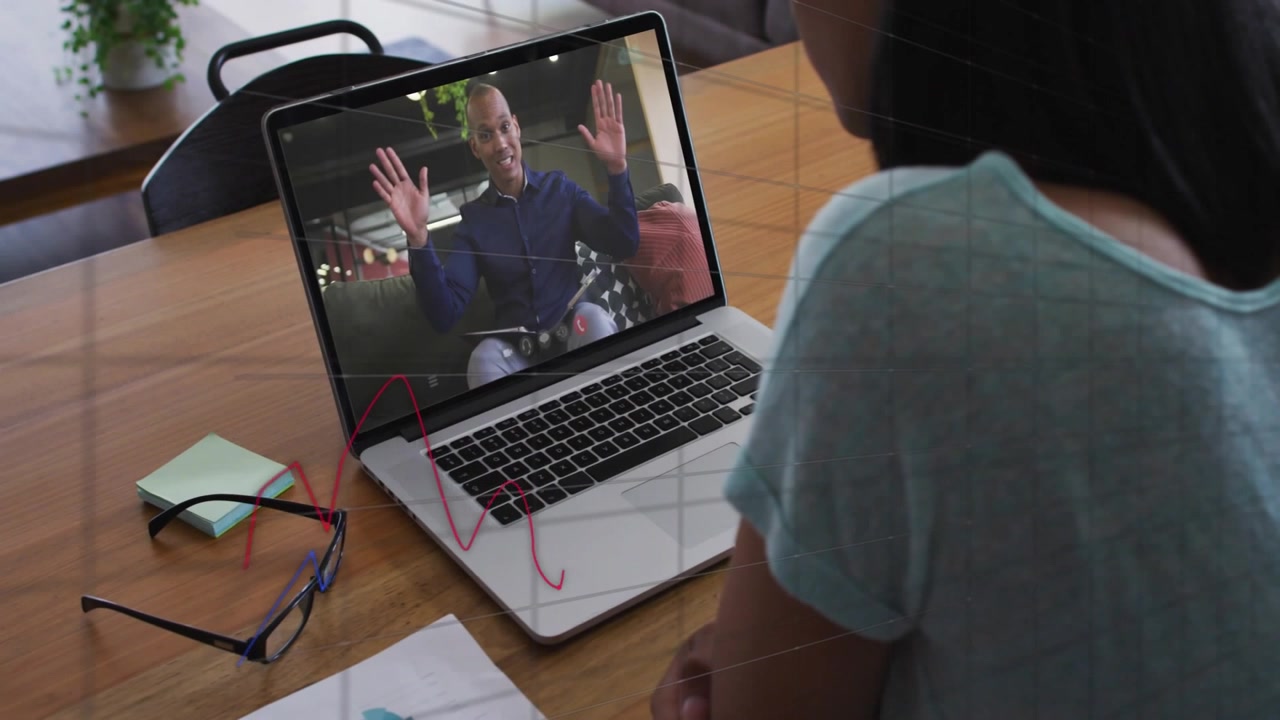 Viewer watching laptop while speaker gesturing, adding red blue charts and % labels for finance