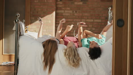 friends hanging out at home dancing to music on smart phone