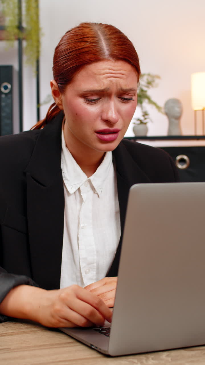Young businesswoman spots debit credit error on laptop crumples paper throws it aside in panic today